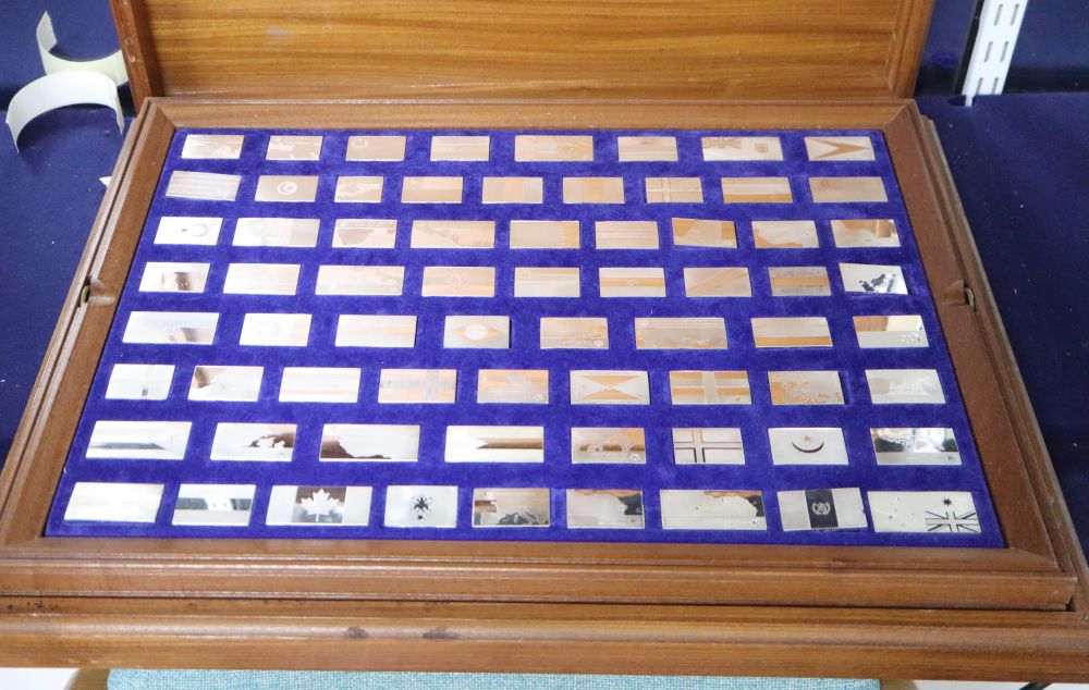 A 1970s John Pinches cased set of one hundred and thirty eight silver ingots, Flags of the United Nations, approx. 133.5oz.